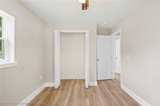 unfurnished bedroom featuring a closet, ceiling fan, and light hardwood / wood-style floors