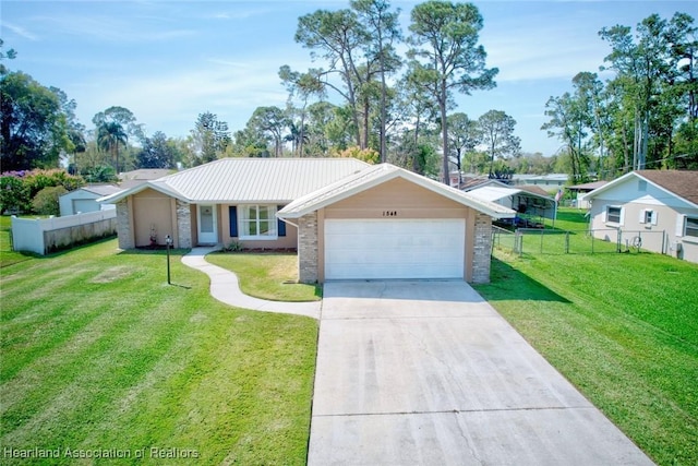 ranch-style home with concrete driveway, fence, a front lawn, and an attached garage