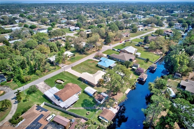 birds eye view of property featuring a water view and a residential view