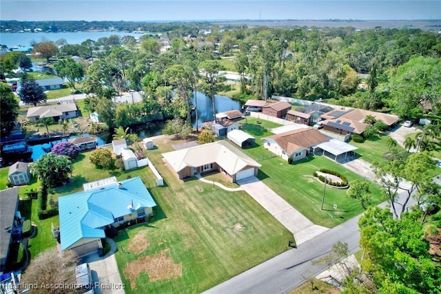 birds eye view of property with a water view and a residential view