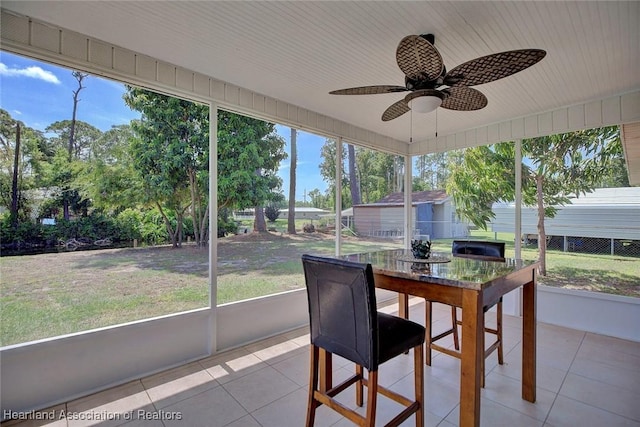 sunroom / solarium with plenty of natural light and ceiling fan