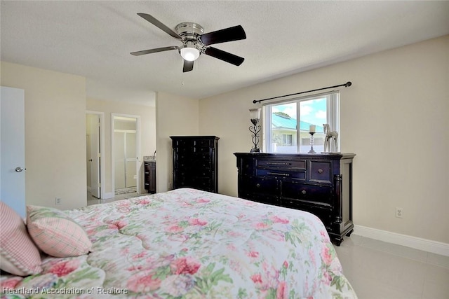 bedroom with ceiling fan, a textured ceiling, and baseboards