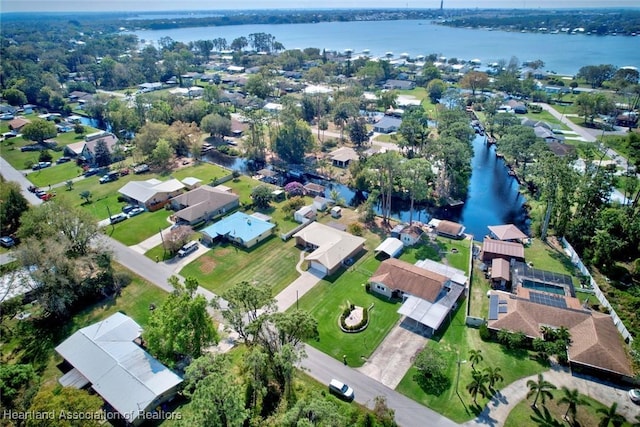 drone / aerial view featuring a water view and a residential view