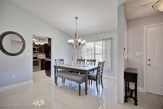 dining space featuring a chandelier, vaulted ceiling, light tile patterned flooring, and baseboards