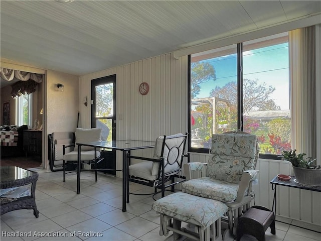 dining space with a wealth of natural light and light tile patterned flooring