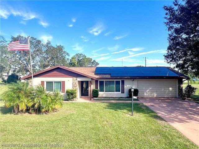 single story home with solar panels, a garage, and a front lawn