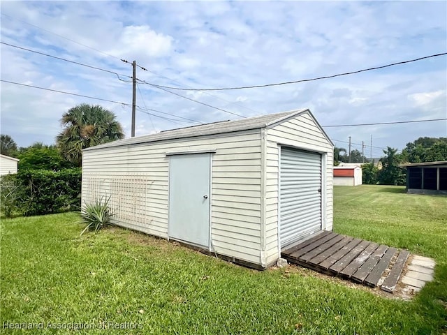 view of outbuilding with a yard