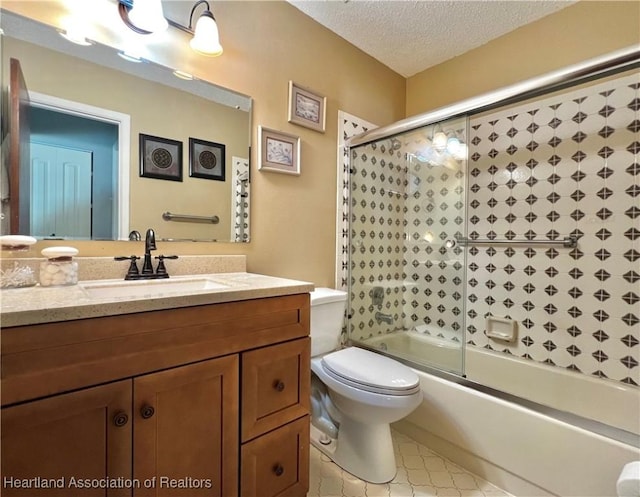 full bathroom featuring vanity, a textured ceiling, toilet, and enclosed tub / shower combo