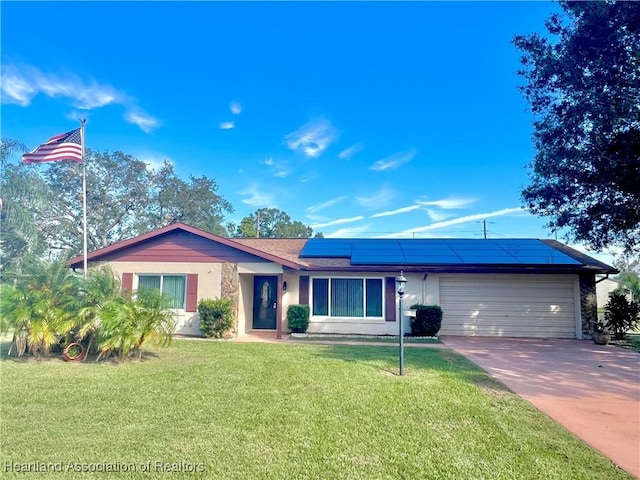 single story home featuring a front lawn, a garage, and solar panels