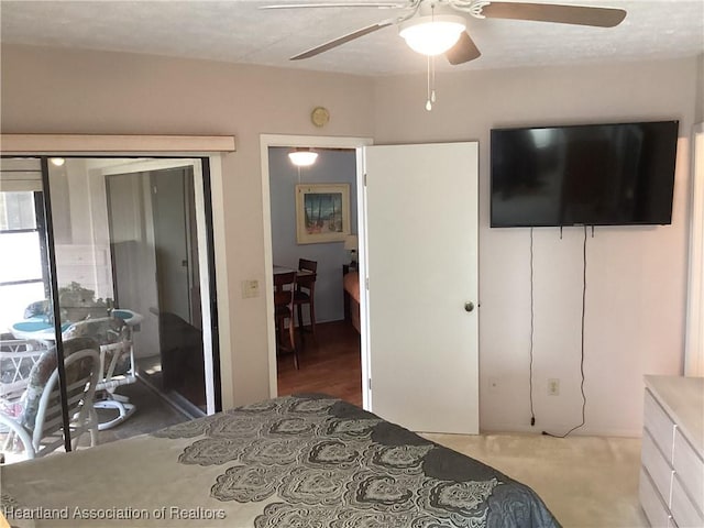 carpeted bedroom featuring ceiling fan