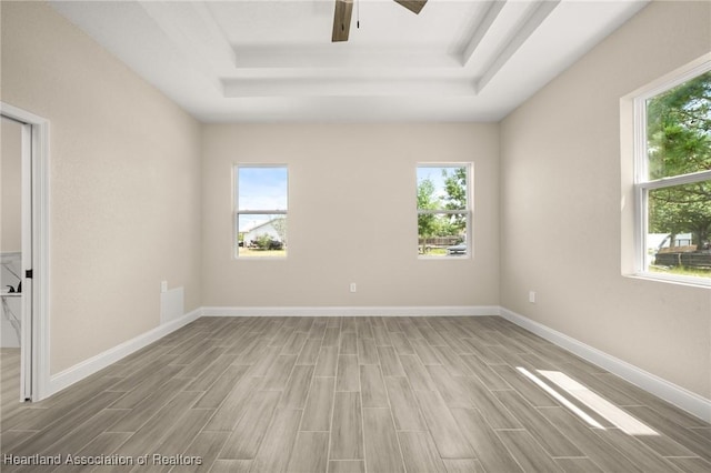 4825 Whiting Dr, Sebring, FL 33870 - unfurnished room with a raised ceiling, wood finished floors, and a wealth of natural light