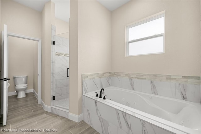 4825 Whiting Dr, Sebring, FL 33870 - full bathroom with toilet, wood finished floors, a stall shower, a jetted tub, and baseboards
