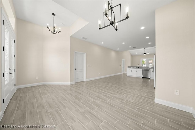4825 Whiting Dr, Sebring, FL 33870 - unfurnished living room featuring light wood finished floors, a notable chandelier, visible vents, baseboards, and recessed lighting