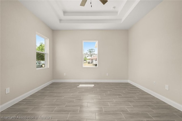4825 Whiting Dr, Sebring, FL 33870 - spare room with ceiling fan, a raised ceiling, baseboards, and wood finished floors
