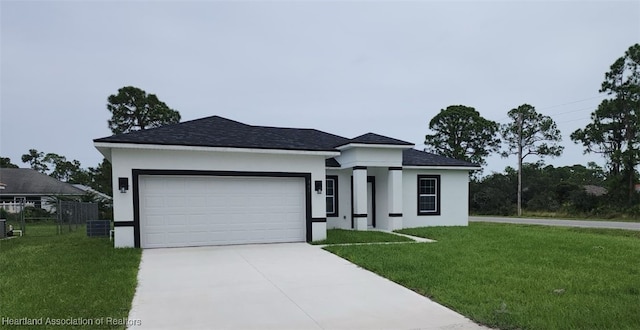 view of front of house with a front lawn and a garage