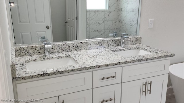 bathroom with vanity and a tub to relax in