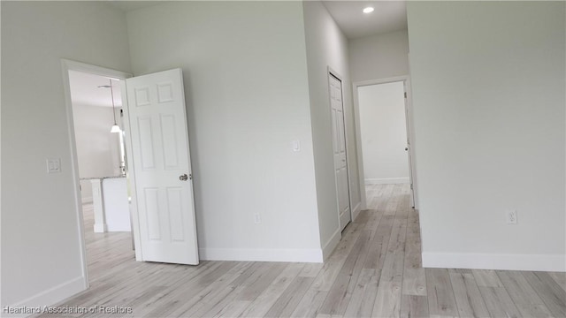 corridor with light hardwood / wood-style floors