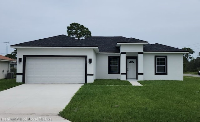 view of front of home with cooling unit, a garage, and a front lawn