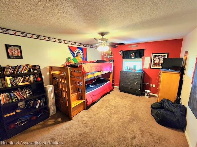 carpeted bedroom featuring a textured ceiling and ceiling fan