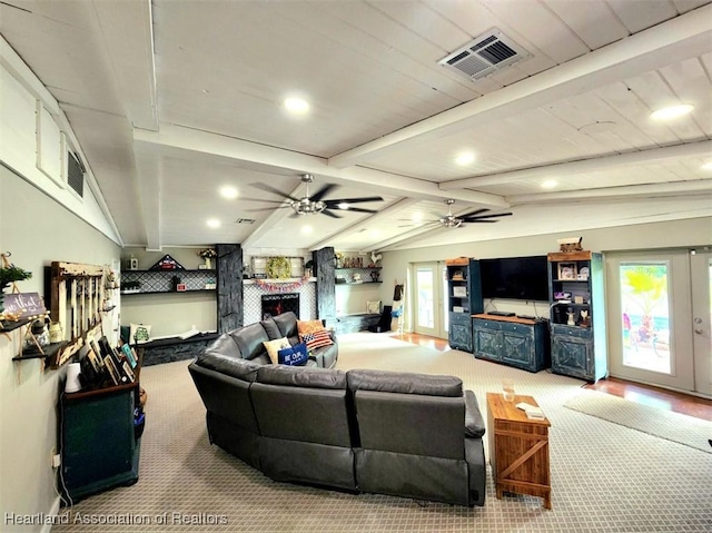 carpeted living room with vaulted ceiling with beams, ceiling fan, and a fireplace