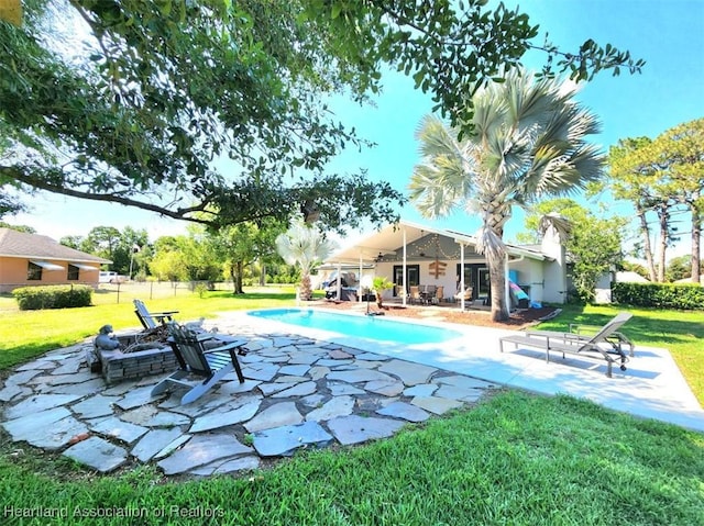 view of swimming pool with a lawn and a patio area