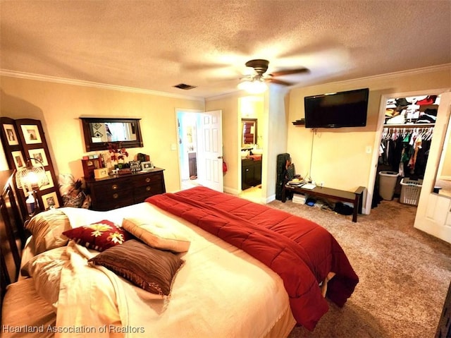 bedroom with light carpet, ensuite bathroom, ornamental molding, a textured ceiling, and a closet