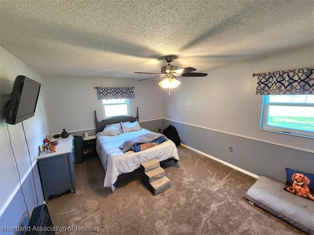 carpeted bedroom featuring a textured ceiling and ceiling fan