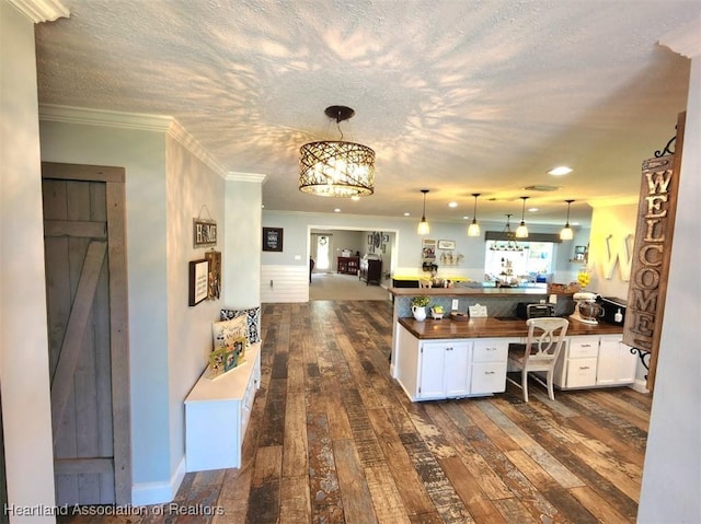 kitchen with white cabinets, butcher block counters, ornamental molding, and dark wood-type flooring