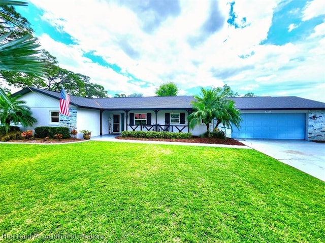 single story home featuring covered porch, a garage, and a front yard