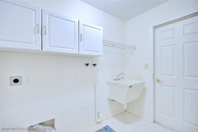 laundry area with cabinets, hookup for a washing machine, electric dryer hookup, sink, and light tile patterned floors