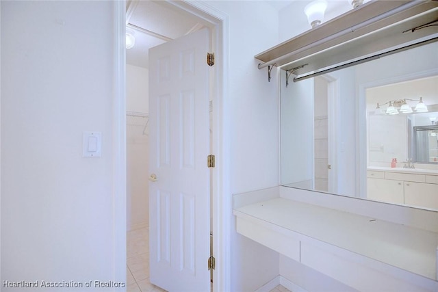 bathroom with tile patterned flooring and vanity