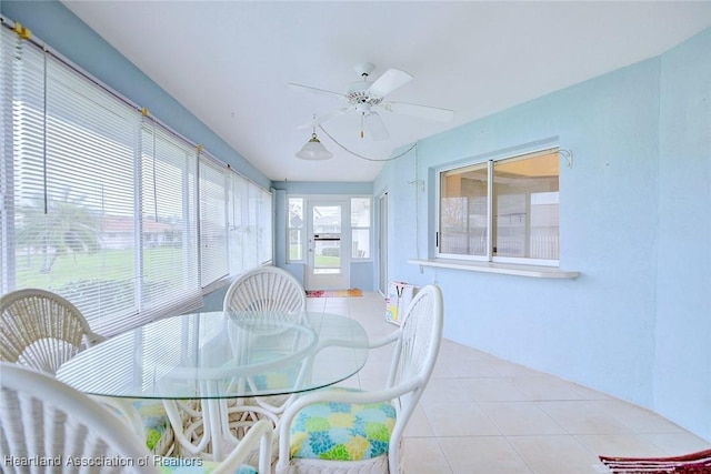 sunroom / solarium featuring ceiling fan