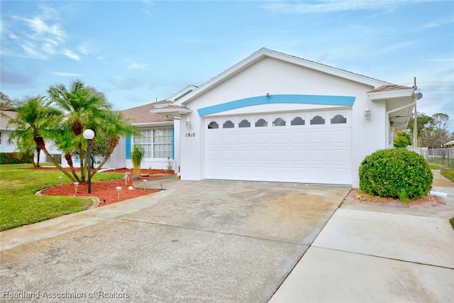 ranch-style house featuring a front lawn and a garage