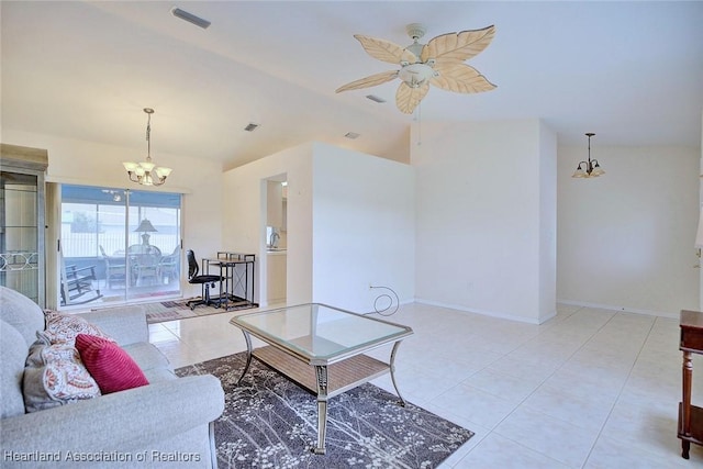 tiled living room with ceiling fan with notable chandelier and lofted ceiling