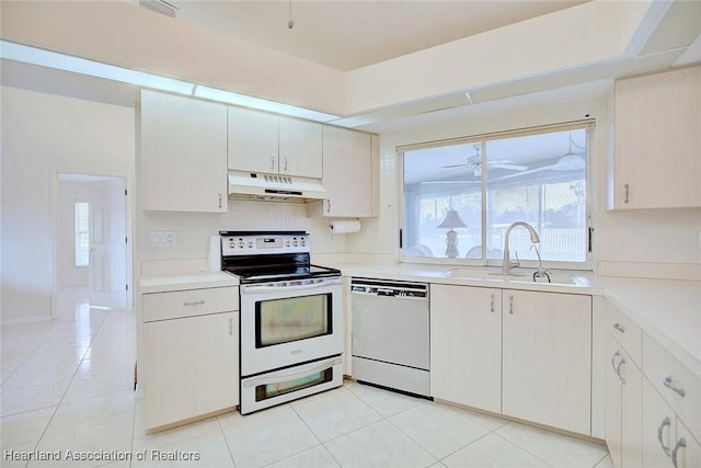 kitchen with white cabinetry, sink, light tile patterned floors, and white appliances