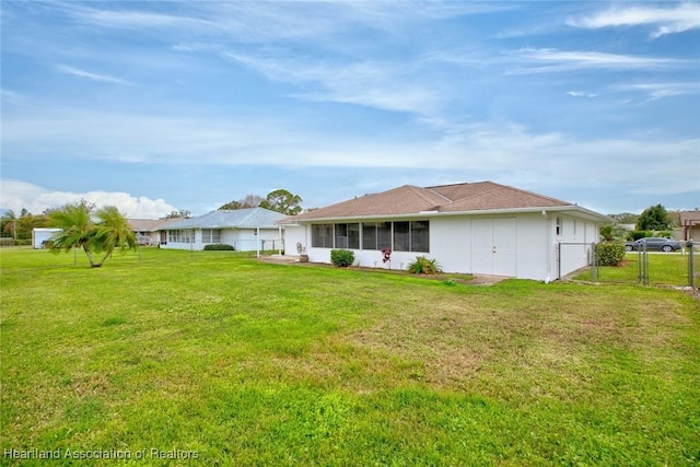 rear view of property featuring a yard