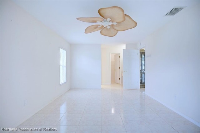 unfurnished room with ceiling fan and light tile patterned floors