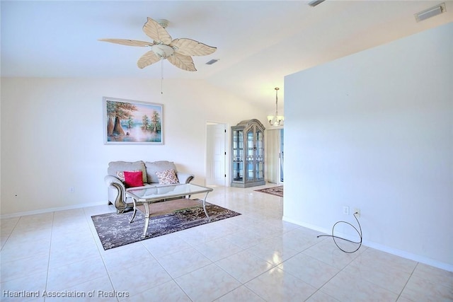 tiled living room featuring ceiling fan with notable chandelier and lofted ceiling