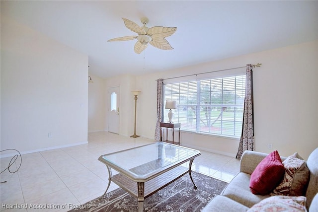 living room with ceiling fan, light tile patterned flooring, and vaulted ceiling