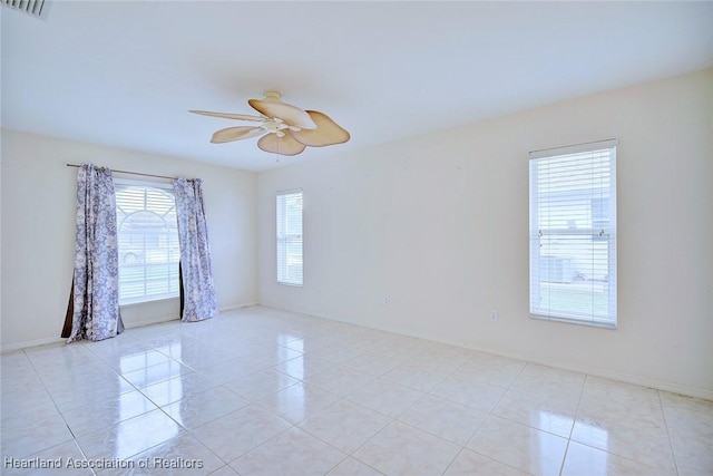 tiled spare room with ceiling fan