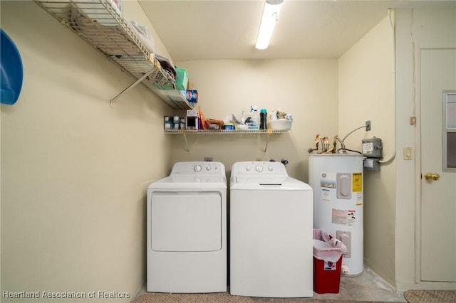 laundry area with electric water heater and washing machine and clothes dryer