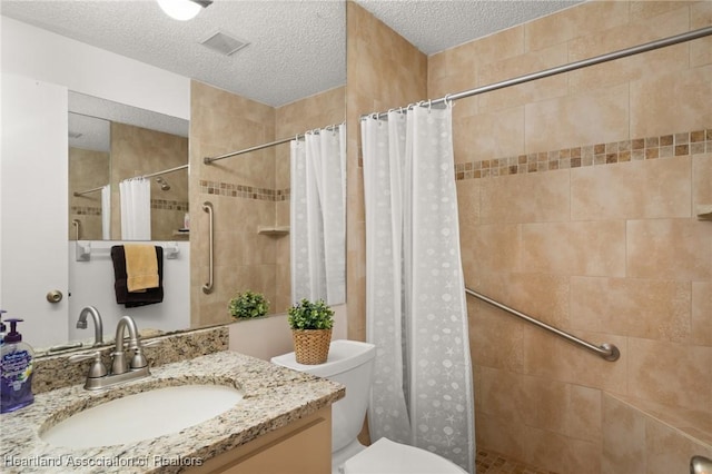 bathroom featuring vanity, a shower with shower curtain, a textured ceiling, and toilet