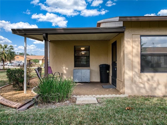 doorway to property with a lawn