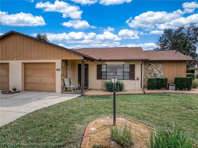 ranch-style home featuring a garage and a front yard