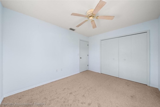 9131 Bridle Path, Sebring, FL 33875 - unfurnished bedroom with carpet floors, a closet, baseboards, and a ceiling fan