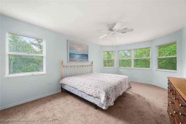 9131 Bridle Path, Sebring, FL 33875 - bedroom featuring light carpet, baseboards, and ceiling fan