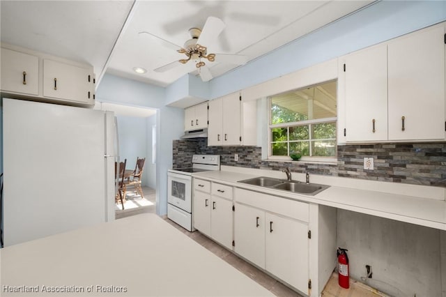 9131 Bridle Path, Sebring, FL 33875 - kitchen with white appliances, a sink, under cabinet range hood, backsplash, and light countertops