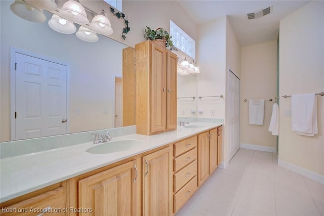 full bathroom with double vanity, tile patterned flooring, a sink, and visible vents