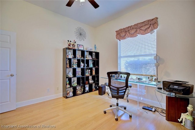 office space with a ceiling fan, baseboards, and wood finished floors