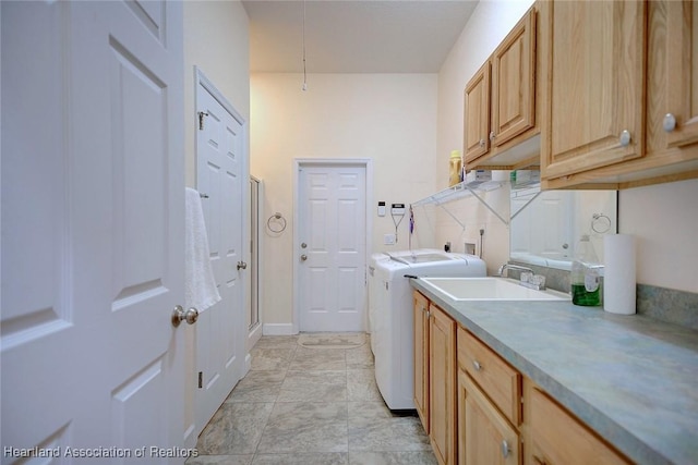 laundry room with independent washer and dryer, a sink, and cabinet space